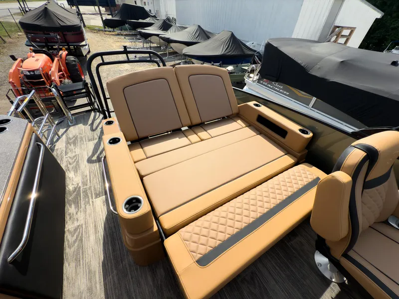 Slide: The Image of Luxurious seating on 2026 Godfrey AquaPatio 23' Flip Lounge Tritoon, featuring tan upholstery and cup holders. - 61