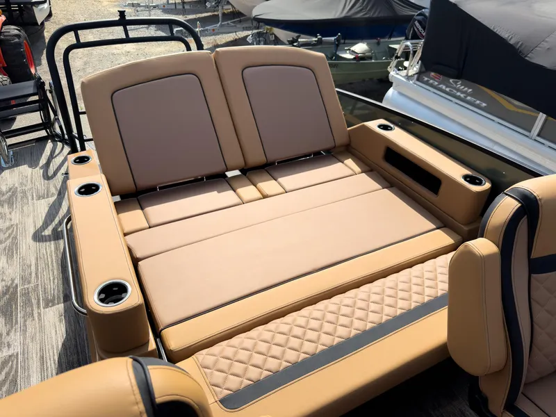 Slide: The Image of Luxurious seating on 2026 Godfrey AquaPatio 23' Flip Lounge Tritoon boat, featuring cup holders. - 62