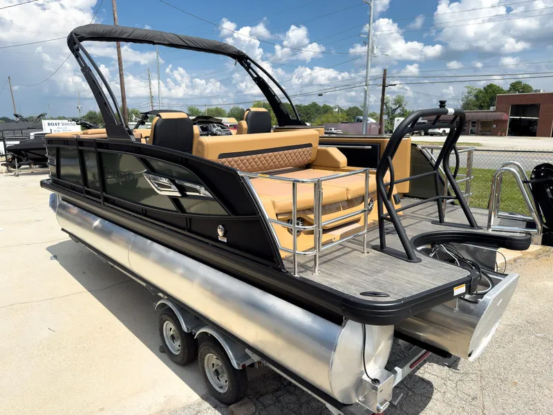 Slide: The Image of 2026 Godfrey AquaPatio 23' Flip Lounge Tritoon, sleek design, tan seating, on trailer, sunny day. - 77