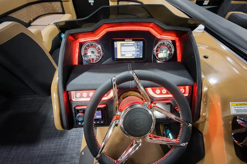 Slide: The Image of 2026 Godfrey Aquapatio 235 ULC dashboard with illuminated controls and modern steering wheel. - 11