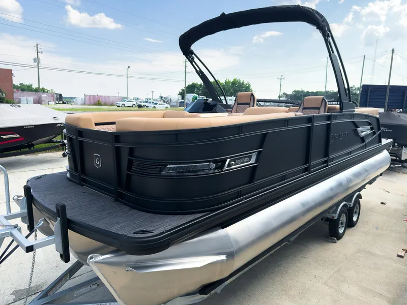 Slide: The Image of Luxurious interior of 2026 Godfrey Aquapatio 235 ULC Tritoon with tan seating and modern dashboard. - 20