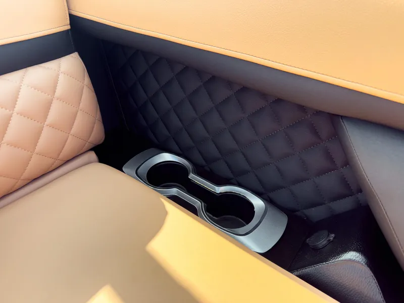 Slide: The Image of 2026 Godfrey Aquapatio 235 ULC Tritoon with luxurious seating at a boat show. - 29