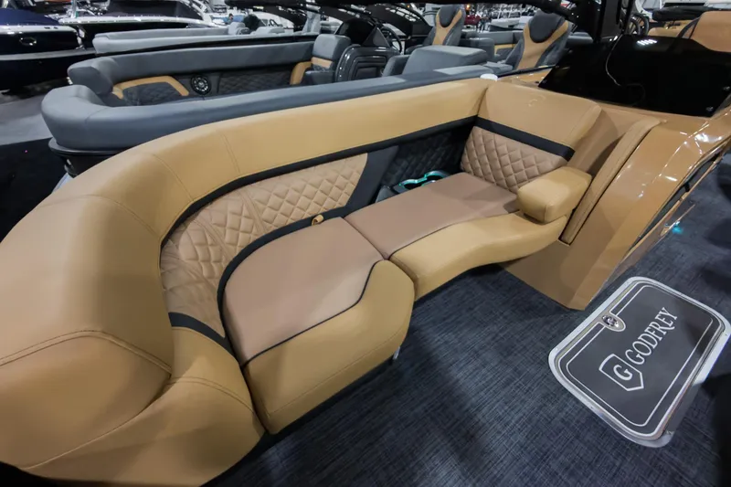 Slide: The Image of Luxurious seating in 2026 Godfrey Aquapatio 235 ULC Tritoon boat, featuring elegant tan upholstery. - 3