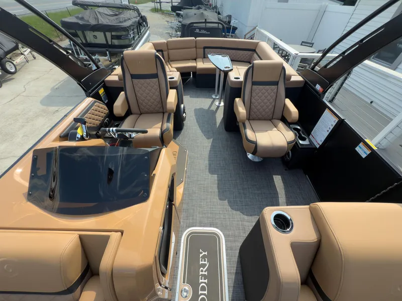 Slide: The Image of 2026 Godfrey Aquapatio 235 ULC Tritoon with tan seating, black exterior, and trailer. - 32
