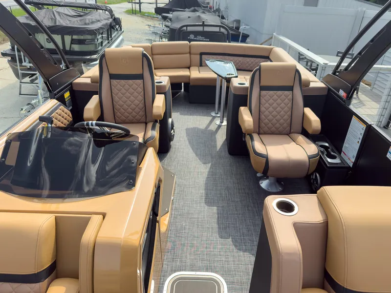 Slide: The Image of 2026 Godfrey Aquapatio 235 ULC Tritoon boat on trailer, parked in front of a house. - 33