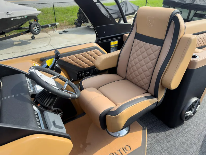 Slide: The Image of 2026 Godfrey Aquapatio 235 ULC Tritoon with luxurious tan seating and spacious layout. - 36