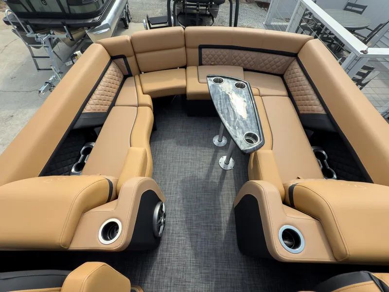 Slide: The Image of 2026 Godfrey Aquapatio 235 ULC Tritoon with luxurious tan seating and sleek dashboard design. - 46