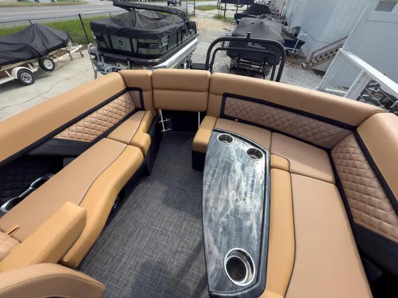 Slide: The Image of Luxurious helm of 2026 Godfrey Aquapatio 235 ULC Tritoon with plush seating and modern controls. - 49