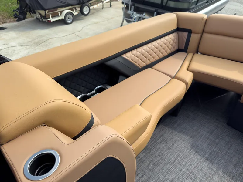 Slide: The Image of Interior of 2026 Godfrey Aquapatio Tritoon with cup holders and control panel. - 52