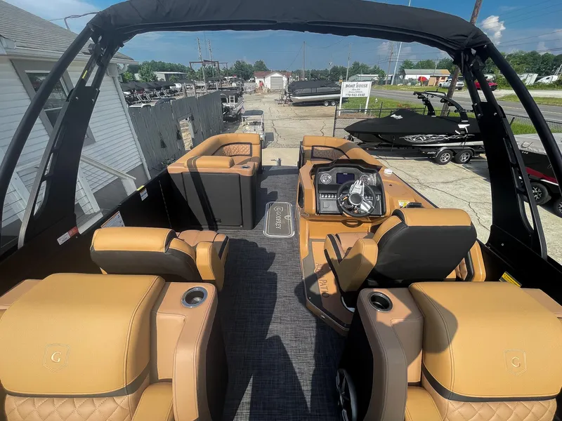 Slide: The Image of 2026 Godfrey Aquapatio 235 ULC Tritoon interior with ultra lounge seating and storage compartment. - 56