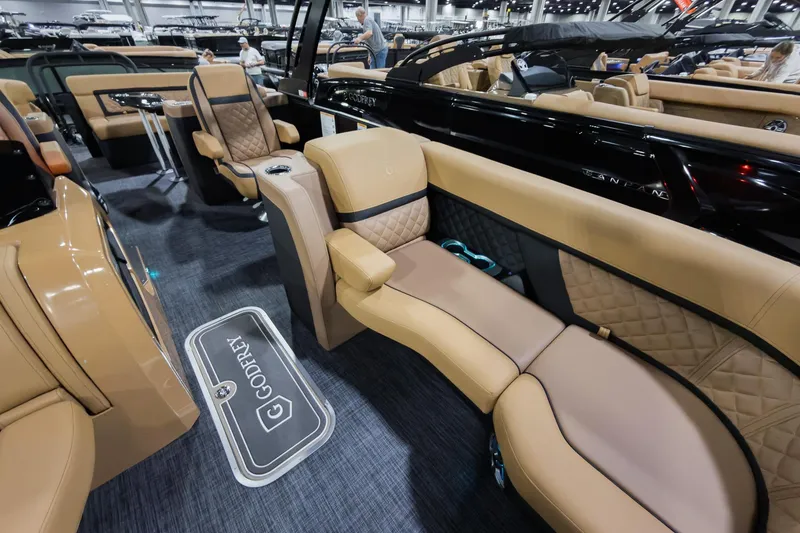 Slide: The Image of Luxurious interior of 2026 Godfrey Aquapatio Ultra Lounge Tritoon with tan seating. - 7