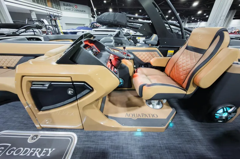 Slide: The Image of 2026 Godfrey Aquapatio 235 ULC Tritoon interior with luxurious seating and modern dashboard. - 9