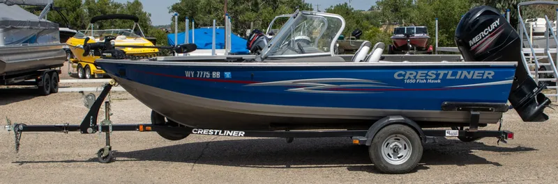 Slide: The Image of 2013 Crestliner 1650 Fish Hawk boat on trailer, parked outdoors. - 3