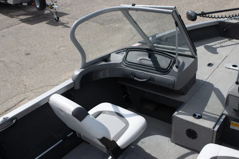 Slide: The Image of 2013 Crestliner 1650 Fish Hawk interior with seating and windshield, ideal for fishing trips. - 5
