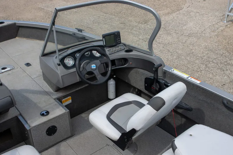 Slide: The Image of 2013 Crestliner 1650 Fish Hawk boat interior with steering wheel and seating. - 6