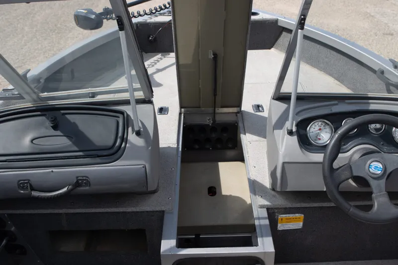 Slide: The Image of 2013 Crestliner 1650 Fish Hawk boat interior with steering wheel and dashboard controls. - 7