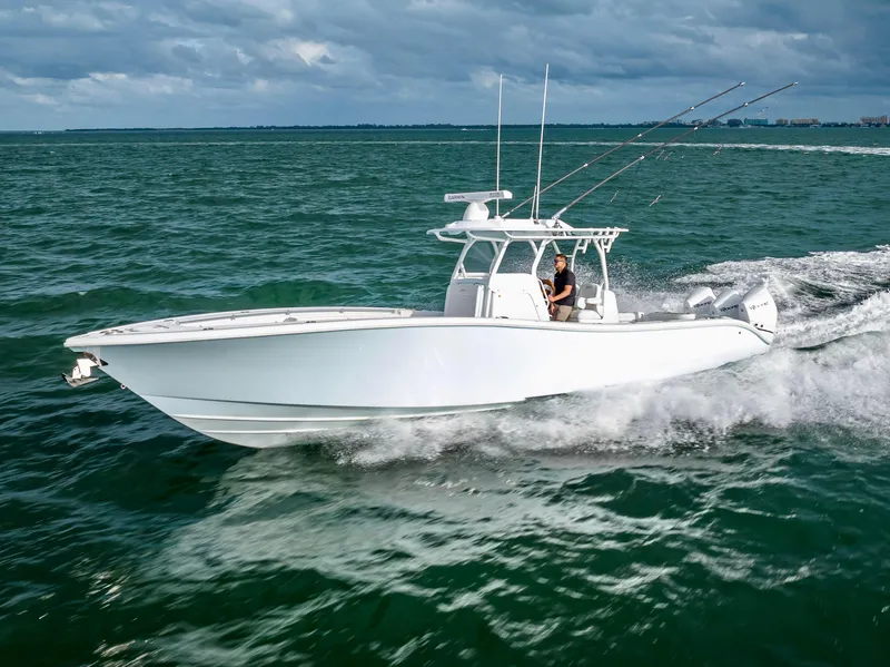 Slide: The Image of 2023 Yellowfin 36 boat cruising on open water under cloudy skies. - 1