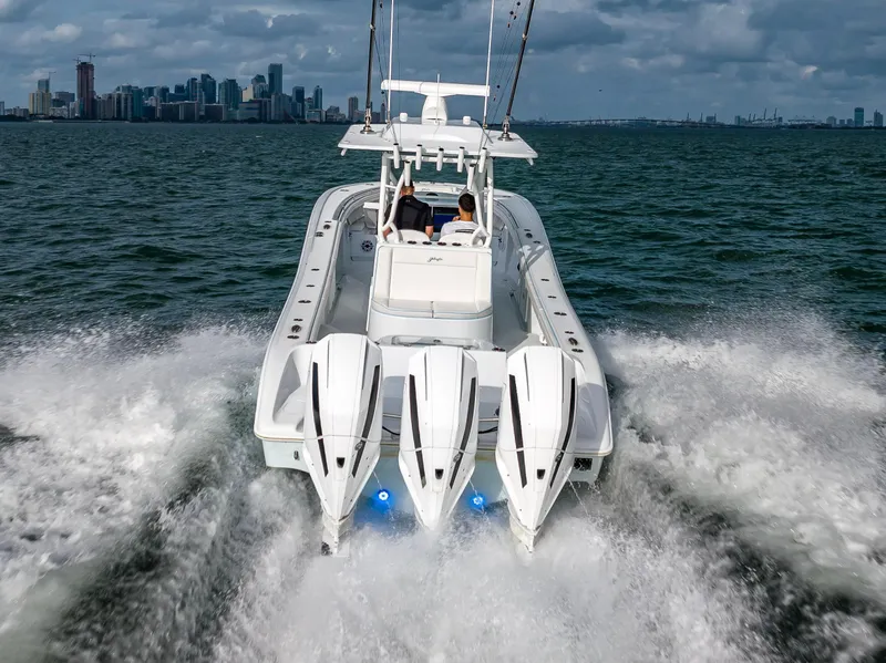 Slide: The Image of 2023 Yellowfin 36 boat cruising on water with city skyline in background. - 17