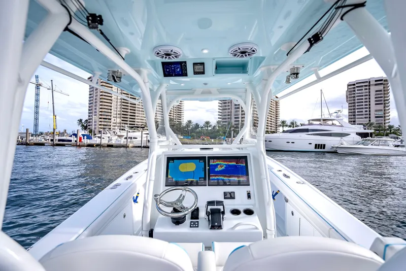 Slide: The Image of 2023 Yellowfin 36 boat interior with advanced navigation system, docked in a marina. - 20