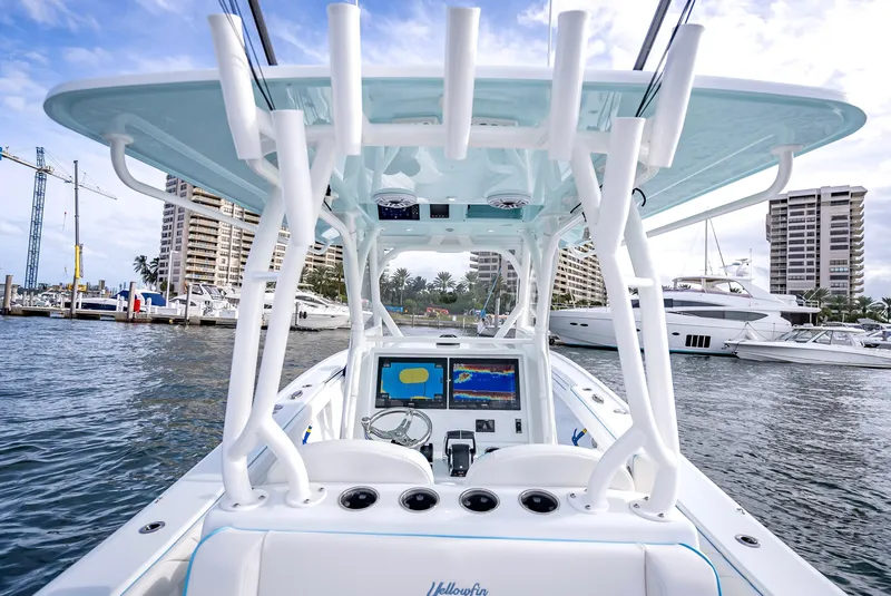 Slide: The Image of 2023 Yellowfin 36 boat interior with modern navigation system, docked in a marina. - 21