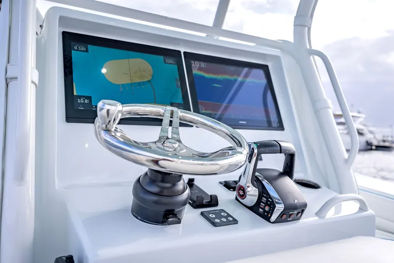 Slide: The Image of 2023 Yellowfin 36 boat helm with dual navigation screens and steering wheel. - 26