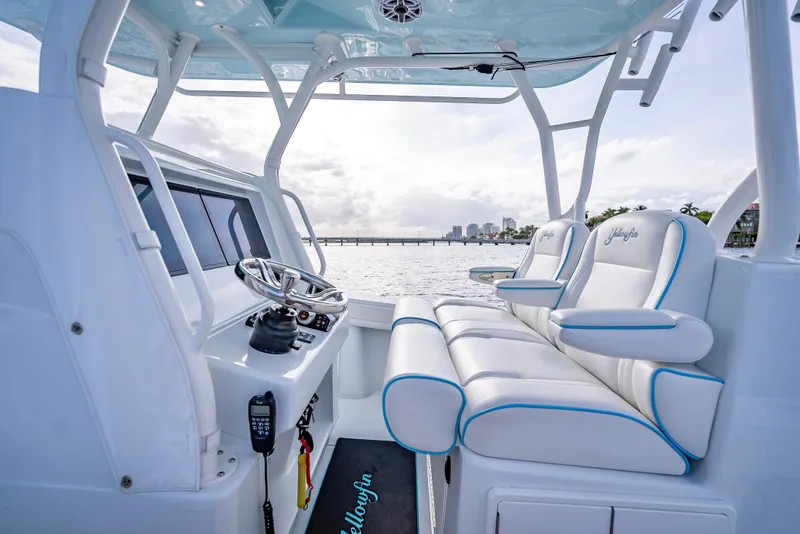 Slide: The Image of 2023 Yellowfin 36 boat interior with plush seating and modern helm, overlooking serene waters. - 27