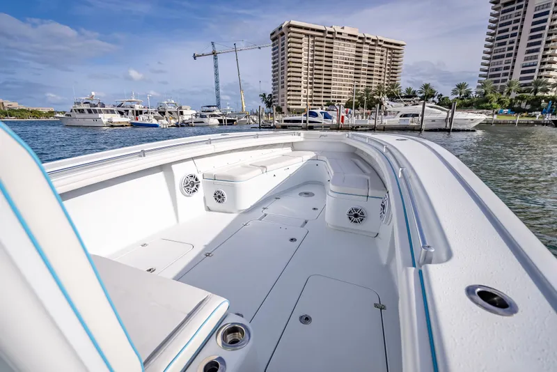 Slide: The Image of 2023 Yellowfin 36 boat docked at marina with luxury yachts and waterfront buildings. - 33