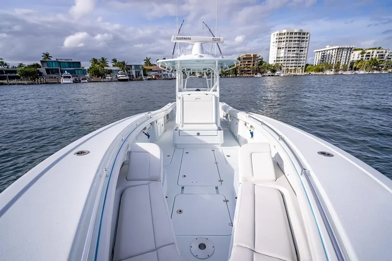 Slide: The Image of 2023 Yellowfin 36 boat on water, cityscape background, clear sky. - 35