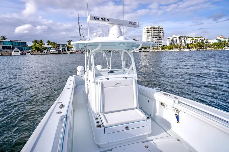 Slide: The Image of 2023 Yellowfin 36 boat on water, featuring Garmin equipment, with cityscape in the background. - 36