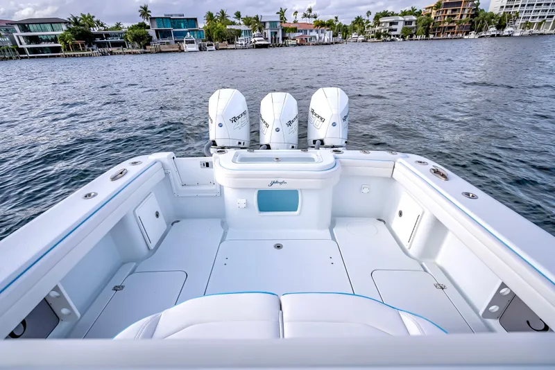 Slide: The Image of 2023 Yellowfin 36 boat with triple engines on a calm waterfront. - 39