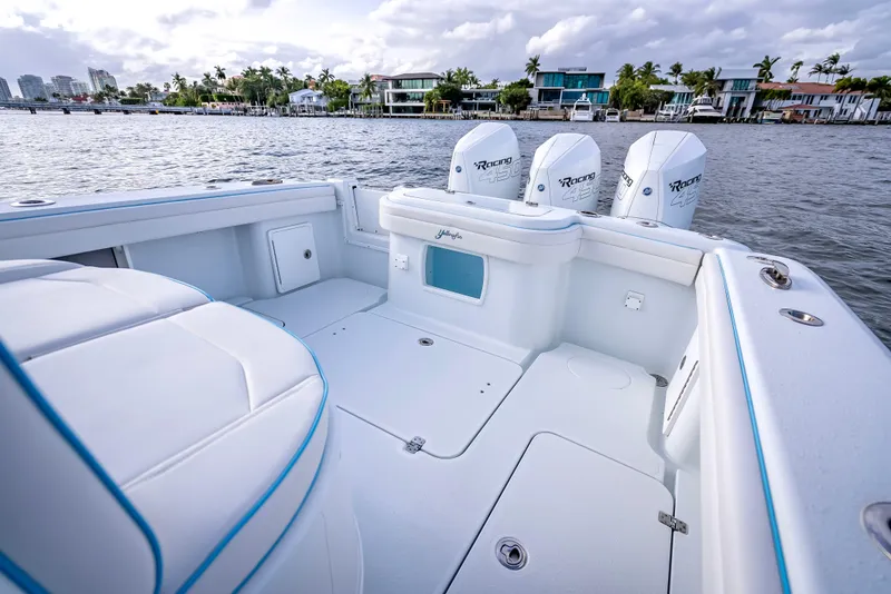 Slide: The Image of 2023 Yellowfin 36 boat with triple engines, docked near waterfront homes. - 40
