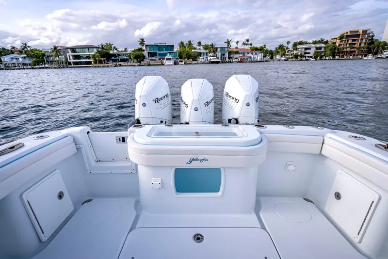 Slide: The Image of 2023 Yellowfin 36 boat with triple Mercury engines on a calm waterfront. - 41