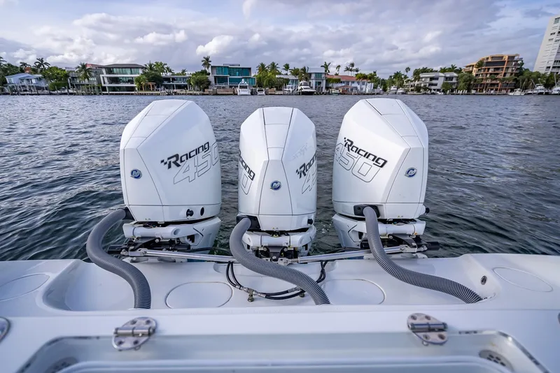 Slide: The Image of 2023 Yellowfin 36 boat with triple outboard engines on a calm waterfront. - 43