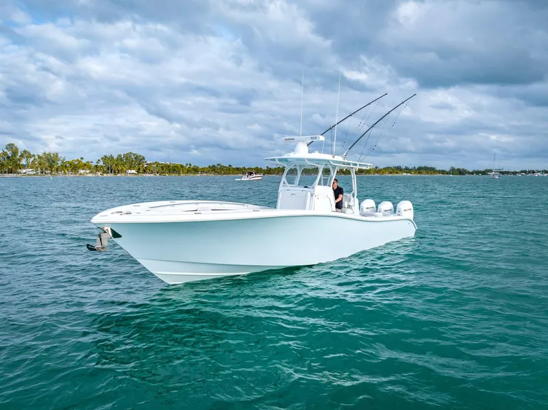 Slide: The Image of 2023 Yellowfin 36 boat on open water under cloudy sky. - 9