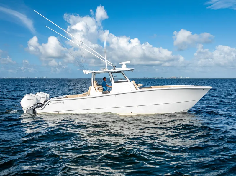 Slide: The Image of 2025 Freeman 35 boat cruising on open water under a clear blue sky. - 0