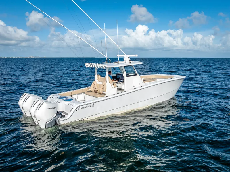 Slide: The Image of 2025 Freeman 35 boat on open ocean, clear sky, twin Mercury engines. - 1