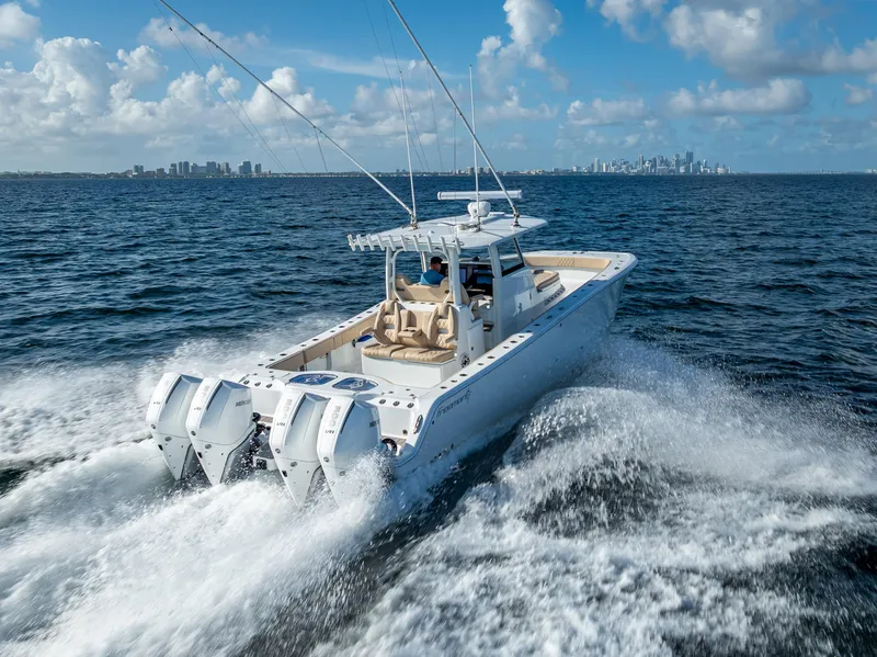 Slide: The Image of 2025 Freeman 35 boat cruising on open water with city skyline in background. - 10