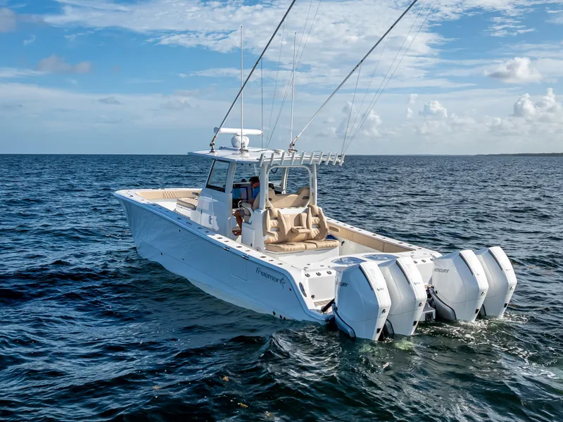 Slide: The Image of 2025 Freeman 35 boat cruising on open ocean under clear blue sky. - 12
