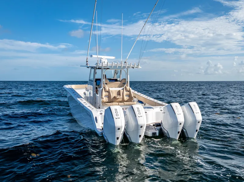 Slide: The Image of 2025 Freeman 35 boat with four engines cruising on open sea under blue sky. - 13