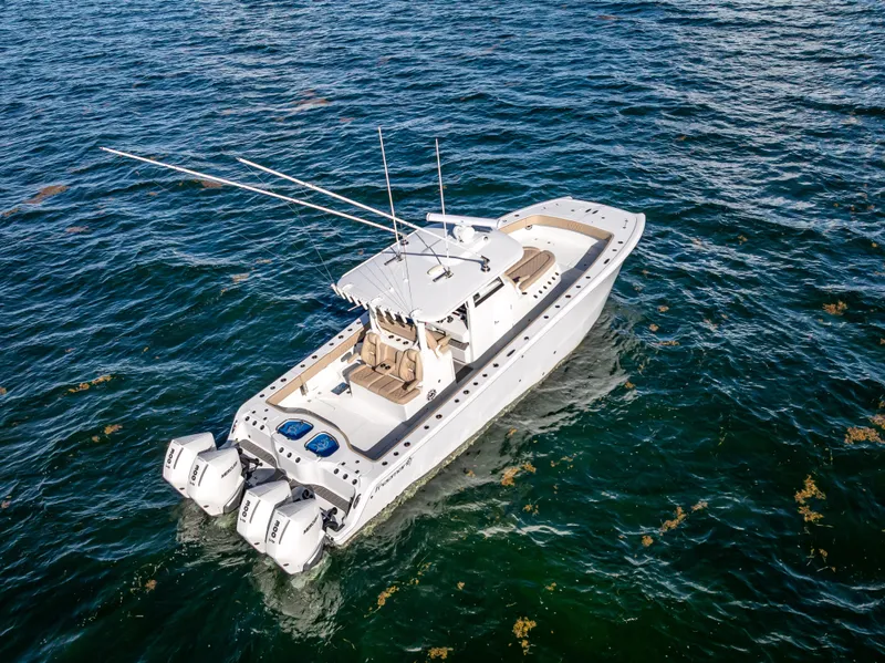 Slide: The Image of 2025 Freeman 35 boat on open water, featuring dual outboard engines. - 15