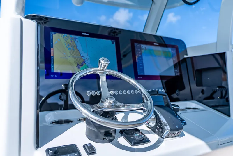 Slide: The Image of Helm of Freeman 35 boat, featuring modern navigation displays and controls, 2025 model. - 18