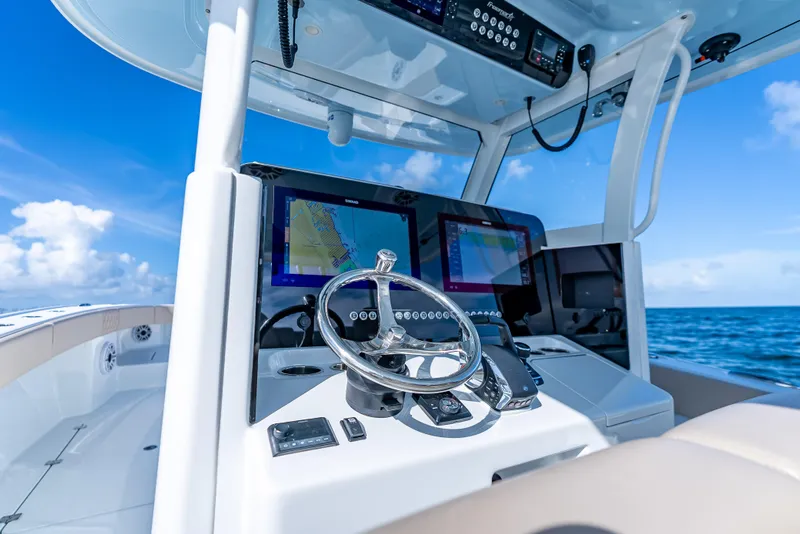Slide: The Image of Helm of 2025 Freeman 35 boat with navigation screens and ocean view. - 19
