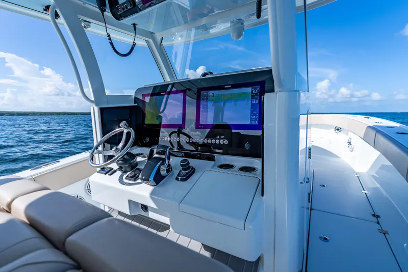 Slide: The Image of Modern Freeman 35 boat cockpit with advanced navigation system, steering wheel, and ocean view, 2025 model. - 21