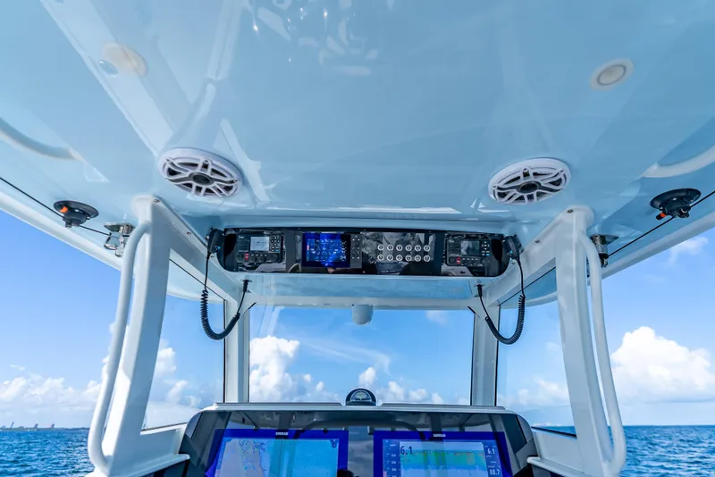 Slide: The Image of 2025 Freeman 35 boat dashboard with navigation equipment, speakers, and ocean view. - 22