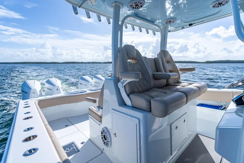 Slide: The Image of Luxury Freeman 35 boat interior with plush seating, ocean view, and multiple Mercury engines, 2025 model. - 26