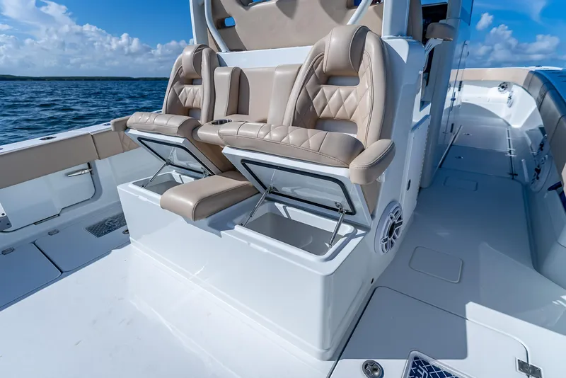 Slide: The Image of Luxury seating on a 2025 Freeman 35 boat with storage compartments, ocean view. - 33