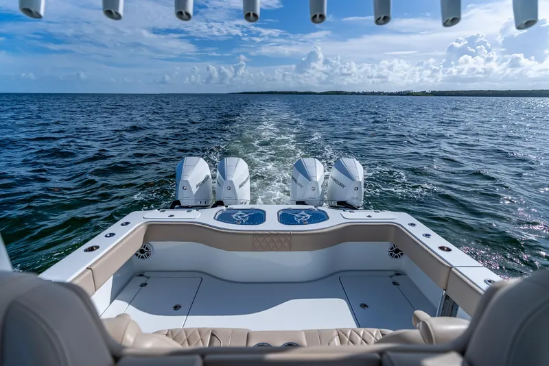 Slide: The Image of Freeman 35 boat cruising on open water, featuring powerful Mercury engines, 2025 model. - 37