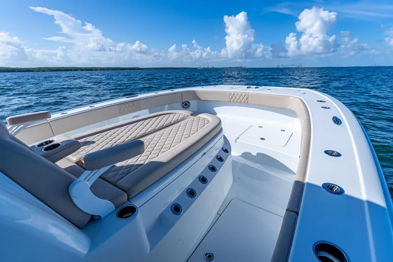 Slide: The Image of Luxurious 2025 Freeman 35 boat interior with cushioned seating, cruising on open blue waters. - 41