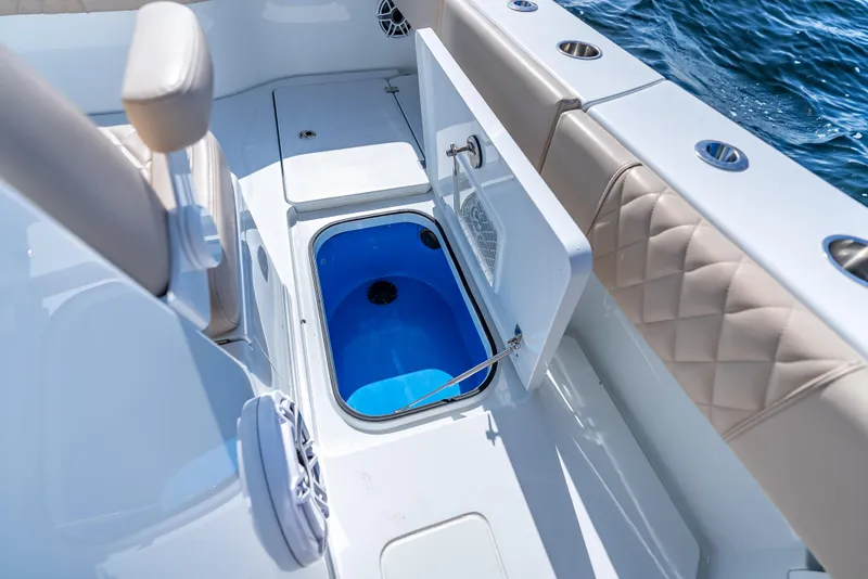 Slide: The Image of 2025 Freeman 35 boat interior with open storage compartment, blue interior, and quilted seating. - 48