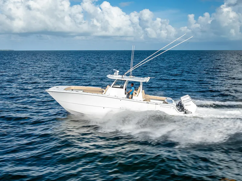 Slide: The Image of 2025 Freeman 35 boat cruising on open ocean under clear blue sky. - 6